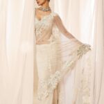 Mouni Roy Instagram - My front row cliché 🤍 #ASareeGirlForever • • • Dressed in @rohitbalofficial Jewels @anmoljewellers Rings @narayanjewels Styled by @manekaharisinghani Hair by @hairbysharda Make up by @chettiaralbert Shot by @trishasarang