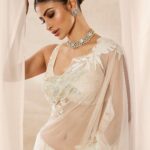 Mouni Roy Instagram - My front row cliché 🤍 #ASareeGirlForever • • • Dressed in @rohitbalofficial Jewels @anmoljewellers Rings @narayanjewels Styled by @manekaharisinghani Hair by @hairbysharda Make up by @chettiaralbert Shot by @trishasarang