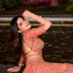 Sakshi Agarwal Instagram - She remembered who she was and the game changed✨ . @murugeshmakeup_hair @malgudi_designs @sathyaphotography3 @fineshinejewels @elementsoneastcoast . #lehenga #princess #orangelehenga #backpose #sakshiagarwal #kollywood Chennai, India