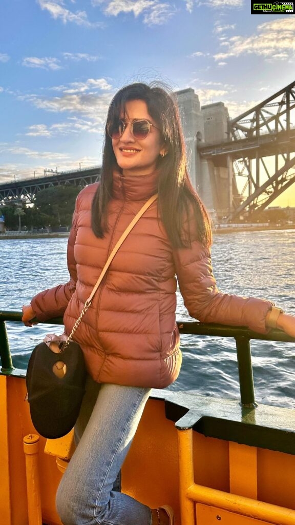 Vimala Raman Instagram - When the magic hour fills my soul ☀️⛅️⛴️🧡 . . . . #instareels #reelitfeelit #reels #travel #sydney #australia #harbourbridge #cruise #waters #goldenhour #golden #home #winter #sunset #love #actor #actress #vimalaraman #lifeisbeautiful