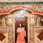 Anupama Gowda Instagram - Jaipur 🌸 1. City palace Every inch of this palace is mesmerising 💓 Love it Love it Love it ! Made of red and pink sandstone , antique artwork and intricate details. To this day, City palace is home to the present royal family of Jaipur. I took City palace Royal tour (3,000/- per person ) where I got the access to visit the upper floors of Chandra Mahal with private guide and in the end complimentary Chai with cookies. 1st floor - Maharaja Sawai Man Singh || Museum. 2nd floor - Sukh Niwas / Blue room. 3rd and 4th floors - Mirror Room and Shobha Niwas. 2. Patrika Gate One of the beautiful locations of Jaipur,it was built to showcase the architectural and cultural heritage of all the regions of Rajasthan. It will be crowded after 10:30 so plan to visit this place around 9 to get some amazing pictures and to enjoy the view. (No entry fees) #travelwithnu💗 Travelling partner: @zipntrip_travel_solutions PC : My tour guide Mr. Rajvendrisingh 🙏🏻 PS: Who clicks your pictures when you go on a solo?? Well, I shamelessly ask everyone to click my pictures and this time I did click few pictures with them too , so swipe left to see my photographer 🤷🏻‍♀️ jaipur,rajesthan