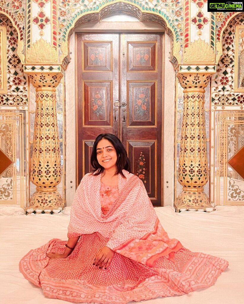 Anupama Gowda Instagram - Jaipur 🌸 1. City palace Every inch of this palace is mesmerising 💓 Love it Love it Love it ! Made of red and pink sandstone , antique artwork and intricate details. To this day, City palace is home to the present royal family of Jaipur. I took City palace Royal tour (3,000/- per person ) where I got the access to visit the upper floors of Chandra Mahal with private guide and in the end complimentary Chai with cookies. 1st floor - Maharaja Sawai Man Singh || Museum. 2nd floor - Sukh Niwas / Blue room. 3rd and 4th floors - Mirror Room and Shobha Niwas. 2. Patrika Gate One of the beautiful locations of Jaipur,it was built to showcase the architectural and cultural heritage of all the regions of Rajasthan. It will be crowded after 10:30 so plan to visit this place around 9 to get some amazing pictures and to enjoy the view. (No entry fees) #travelwithnu💗 Travelling partner: @zipntrip_travel_solutions PC : My tour guide Mr. Rajvendrisingh 🙏🏻 PS: Who clicks your pictures when you go on a solo?? Well, I shamelessly ask everyone to click my pictures and this time I did click few pictures with them too , so swipe left to see my photographer 🤷🏻‍♀️ jaipur,rajesthan