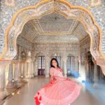 Anupama Gowda Instagram - Jaipur 🌸 1. City palace Every inch of this palace is mesmerising 💓 Love it Love it Love it ! Made of red and pink sandstone , antique artwork and intricate details. To this day, City palace is home to the present royal family of Jaipur. I took City palace Royal tour (3,000/- per person ) where I got the access to visit the upper floors of Chandra Mahal with private guide and in the end complimentary Chai with cookies. 1st floor - Maharaja Sawai Man Singh || Museum. 2nd floor - Sukh Niwas / Blue room. 3rd and 4th floors - Mirror Room and Shobha Niwas. 2. Patrika Gate One of the beautiful locations of Jaipur,it was built to showcase the architectural and cultural heritage of all the regions of Rajasthan. It will be crowded after 10:30 so plan to visit this place around 9 to get some amazing pictures and to enjoy the view. (No entry fees) #travelwithnu💗 Travelling partner: @zipntrip_travel_solutions PC : My tour guide Mr. Rajvendrisingh 🙏🏻 PS: Who clicks your pictures when you go on a solo?? Well, I shamelessly ask everyone to click my pictures and this time I did click few pictures with them too , so swipe left to see my photographer 🤷🏻‍♀️ jaipur,rajesthan