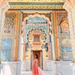 Anupama Gowda Instagram - Jaipur 🌸 1. City palace Every inch of this palace is mesmerising 💓 Love it Love it Love it ! Made of red and pink sandstone , antique artwork and intricate details. To this day, City palace is home to the present royal family of Jaipur. I took City palace Royal tour (3,000/- per person ) where I got the access to visit the upper floors of Chandra Mahal with private guide and in the end complimentary Chai with cookies. 1st floor - Maharaja Sawai Man Singh || Museum. 2nd floor - Sukh Niwas / Blue room. 3rd and 4th floors - Mirror Room and Shobha Niwas. 2. Patrika Gate One of the beautiful locations of Jaipur,it was built to showcase the architectural and cultural heritage of all the regions of Rajasthan. It will be crowded after 10:30 so plan to visit this place around 9 to get some amazing pictures and to enjoy the view. (No entry fees) #travelwithnu💗 Travelling partner: @zipntrip_travel_solutions PC : My tour guide Mr. Rajvendrisingh 🙏🏻 PS: Who clicks your pictures when you go on a solo?? Well, I shamelessly ask everyone to click my pictures and this time I did click few pictures with them too , so swipe left to see my photographer 🤷🏻‍♀️ jaipur,rajesthan