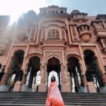 Anupama Gowda Instagram - Jaipur 🌸 1. City palace Every inch of this palace is mesmerising 💓 Love it Love it Love it ! Made of red and pink sandstone , antique artwork and intricate details. To this day, City palace is home to the present royal family of Jaipur. I took City palace Royal tour (3,000/- per person ) where I got the access to visit the upper floors of Chandra Mahal with private guide and in the end complimentary Chai with cookies. 1st floor - Maharaja Sawai Man Singh || Museum. 2nd floor - Sukh Niwas / Blue room. 3rd and 4th floors - Mirror Room and Shobha Niwas. 2. Patrika Gate One of the beautiful locations of Jaipur,it was built to showcase the architectural and cultural heritage of all the regions of Rajasthan. It will be crowded after 10:30 so plan to visit this place around 9 to get some amazing pictures and to enjoy the view. (No entry fees) #travelwithnu💗 Travelling partner: @zipntrip_travel_solutions PC : My tour guide Mr. Rajvendrisingh 🙏🏻 PS: Who clicks your pictures when you go on a solo?? Well, I shamelessly ask everyone to click my pictures and this time I did click few pictures with them too , so swipe left to see my photographer 🤷🏻‍♀️ jaipur,rajesthan