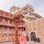 Anupama Gowda Instagram - Jaipur 🌸 1. City palace Every inch of this palace is mesmerising 💓 Love it Love it Love it ! Made of red and pink sandstone , antique artwork and intricate details. To this day, City palace is home to the present royal family of Jaipur. I took City palace Royal tour (3,000/- per person ) where I got the access to visit the upper floors of Chandra Mahal with private guide and in the end complimentary Chai with cookies. 1st floor - Maharaja Sawai Man Singh || Museum. 2nd floor - Sukh Niwas / Blue room. 3rd and 4th floors - Mirror Room and Shobha Niwas. 2. Patrika Gate One of the beautiful locations of Jaipur,it was built to showcase the architectural and cultural heritage of all the regions of Rajasthan. It will be crowded after 10:30 so plan to visit this place around 9 to get some amazing pictures and to enjoy the view. (No entry fees) #travelwithnu💗 Travelling partner: @zipntrip_travel_solutions PC : My tour guide Mr. Rajvendrisingh 🙏🏻 PS: Who clicks your pictures when you go on a solo?? Well, I shamelessly ask everyone to click my pictures and this time I did click few pictures with them too , so swipe left to see my photographer 🤷🏻‍♀️ jaipur,rajesthan