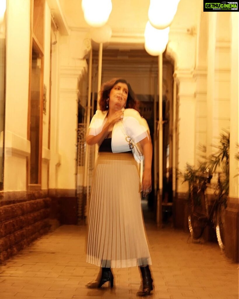 Debina Bonnerjee Instagram - Life is a beautiful blur 🤎🖤 . Black and White Outfit - @calvinklein Pleated skirt - @tommyhilfiger Bag - @dior shoes - @versace Fashion Directed by: @thebongmunda 📸 : @sk_.click Managed by : @jeevitaoberoi
