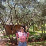 Malavika Mohanan Instagram - In in a very rainy mumbai at the moment, and reminiscing about this lovely afternoon I spent in the High Atlas hills of Morocco. There was brisk mountain air, the most orangey oranges I’ve seen & the cutest little doggo for company 🐶 As you can evidently guess, it was a good day ♥️ Also, wearing the cutest little top by @springorigin which designs the cutest stuff everrrrr How you do this @apurvanayal howw 🤍