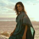 Pallavi Sharda Instagram – Sitting on the Meridian which holds the cusp of my ancestral past and futures, two cultures, two continents – wrapped in a sari I found in my mother’s closet that afternoon. 

Shot by @mauro_palmieri_photographer on the dunes of City Beach in WA on the sacred land of the Nyoongar people, on the Ocean my parents traversed to call this great southern land home. 
Sometimes the liminality of this land digs deeper than words can express. 

Yesterday was #nationalhandloomday. A moment – amongst many –  to celebrate the artisans who weave the threads that envelope us in our histories.

HMU @nadiaduca 
Camera Assist: @chrismartinstudio
Sari: mama’s 
Jewels: @miromirostudio Indian Ocean