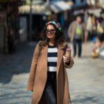 Sharanya Turadi Instagram - Here’s me wandering in the streets of Sirince, a remote little village in Turkey 🇹🇷 The place was bustling with colourful shops, wine tasting breweries and Turkish ice cream corners. Well What I would like you to appreciate is how well I managed to pose without getting that ice cream spilt over my coat 🧥🍦🐒 @gtholidays.in #realproblems #travelgram #turkey #şirince #travel #styling Şirince