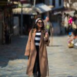 Sharanya Turadi Instagram - Here’s me wandering in the streets of Sirince, a remote little village in Turkey 🇹🇷 The place was bustling with colourful shops, wine tasting breweries and Turkish ice cream corners. Well What I would like you to appreciate is how well I managed to pose without getting that ice cream spilt over my coat 🧥🍦🐒 @gtholidays.in #realproblems #travelgram #turkey #şirince #travel #styling Şirince