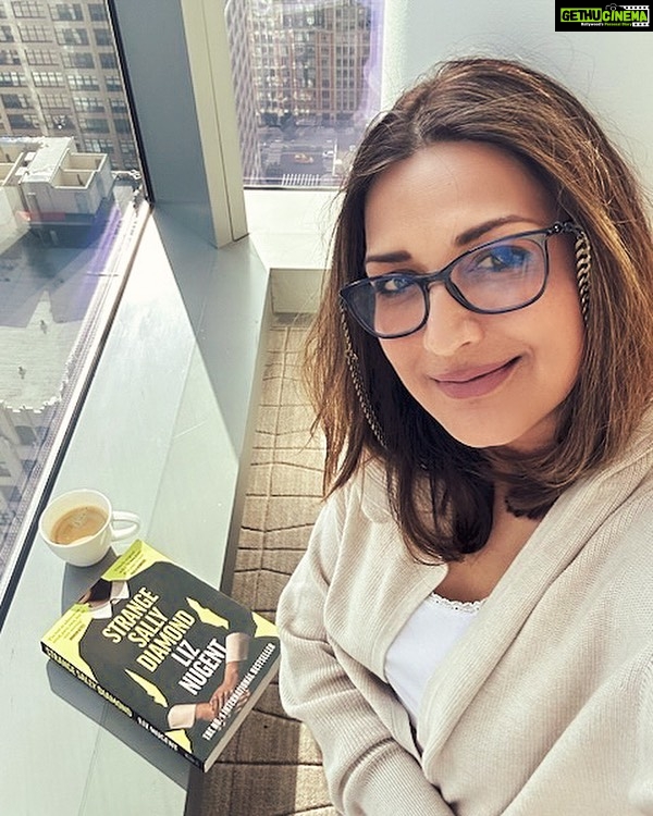 Sonali Bendre Instagram - From high in the sky in New York, its time to announce our next #SBCBookOfTheMonth: Strange Sally Diamond by Liz Nugent. In this compelling and thrilling novel, we follow Sally Diamond's strange journey. From a simple act her father instructed her to do - to dispose of his remains with the trash - to becoming the center of an inexplicable media frenzy and police investigation, Sally also has to deal with a sinister voice from a past she does not remember. As she begins to discover the horrors of her early childhood, Sally steps into the world for the first time, making new friends, big decisions, and learning that people don’t always mean what they say. I can't wait to dive in, and I hope you join me on this literary journey!