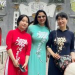 Archita Sahu Instagram - Many of you asked what I was wearing in last few posts . That’s ‘Ao dai’ . It’s the Vietnamese dress basically a silk tunic with straight pants . I got to know about it while talking to few locals who helped me with the shop address too to buy from. And here I am with few newly made local friends ❤️ NB : last pic shows my touristy mode 😂 #aodai #hoankiem #cafe #SabyArchita #archita #travel #road #rickshaw #bus #cafehoankiem #highlandcoffee
