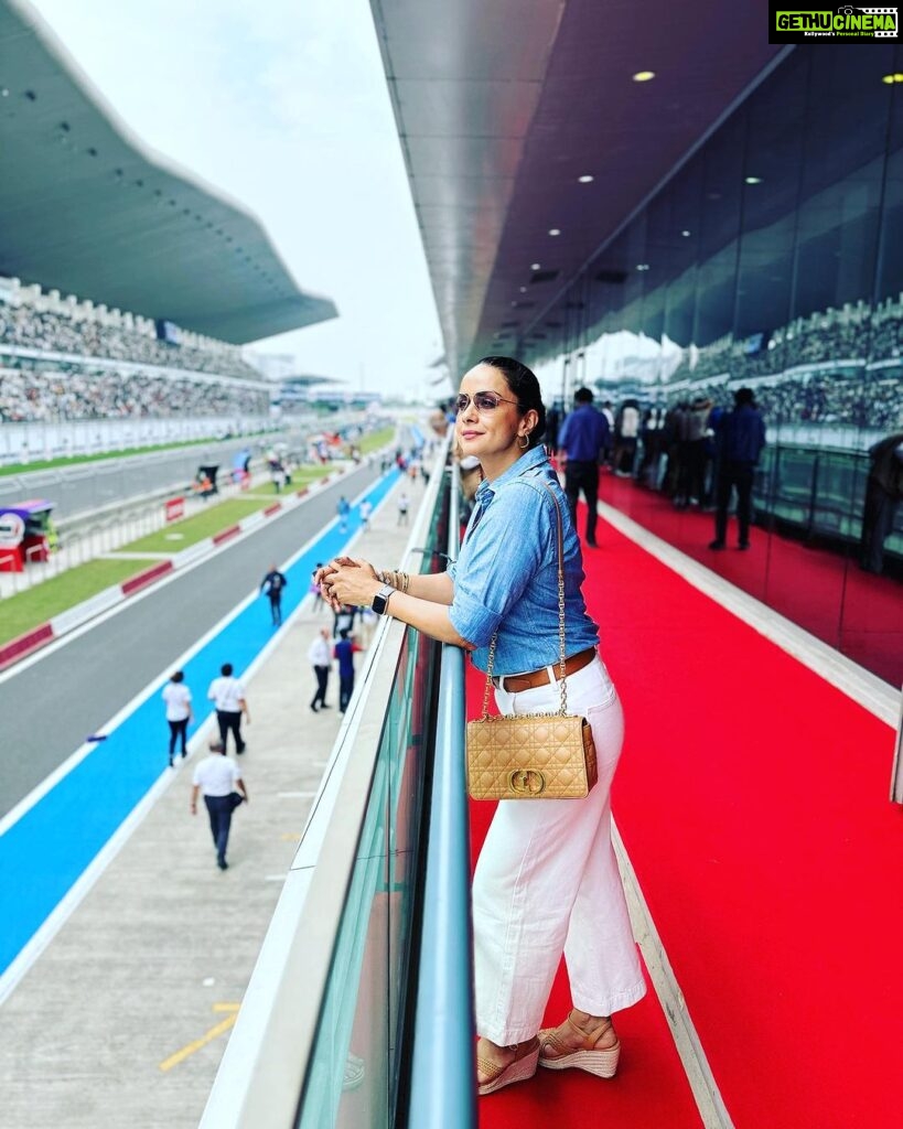 Gul Panag Instagram - Me, I’m happiest on a race track. Dozens of races watched and traveled to. Seen from fancy VVIP lounges to the team garages ( watching from my home team @mahindraracing ‘s garage has been the best ) to actually being lucky enough to drive a few Formula Cars ( F1, courtesy @renault_france , Formula E courtesy my friends @mahindraracing and @gill.dilbagh and more, to trying my hand at racing with the @polocup.india ( remember @rayomandbanajee 😅)- I cannot adequately express my love for motorsport. I’m so thrilled we have seen two big ticket international marquee racing events this year- The Formula E at Hyderabad and the @motogpbharat today at @buddh.international.circuit . Cannot wait for more!! P.S . The shoes I’m wearing, deserve a post of their own. But given that my Instagram game is the most authentic version of what I’m currently doing, I probably may never get down to it. 🤦🏻‍♀️ So here it goes. These are the most comfortable sandals I have worn in a long time. I spent 12 hours in them yesterday. And close to the same number of hours today. Wearing them to a race was a risky decision. Last time I wore any kind of heels to a race , was about 10 years ago and i ended up with blisters the size of grapes on my feet. Never have I since then, , ever ever risked, wearing anything but flats to the races. Ideally trainers .😅 There’s a lot of walking around. I end up doing 6000 odd steps . So, which brings me to this amazing pair by @vanillamoonshoes . 🤩🤩 Ladies ( and gents, if that’s your vibe) highly recommend them. Buddh International Circuit