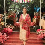 Gul Panag Instagram - The phulkari is such an integral part of our culture. From all things auspicious to all things festive -the phulkari is always there. Either as the main act. Or the supporting one, where we simply carry it on our forearms ( in addition to the full outfit and its own dupatta). At every wedding, shagan, engagement and jaago- the phulkari will ALWAYS make an appearance. Here I’m wearing a bagh ( all over embroidery) from @1469original . Occasion is Vatana. And my outfit is borrowed from @simranpotnis - we’ve decided to have all our clothes in JV now. 😅 Blue sari is @ritukumarhq . From 1999. Qualifies as vintage I suppose Also, managed to get HIM to pose for a picture.😅 @keeratkular thanks for the photos. And for reminding me that the knot clutch exists in my wardrobe. And of course for EVERYTHING else.😂 P.S Phulkari (ਫੁਲਕਾਰੀ) refers to the folk embroidery of the Punjab. Although Phulkari means floral work, the designs include not only flowers but also cover motifs and geometrical shapes. Incidentally, culturally prevalent in Punjab, Pakistan too.