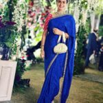 Gul Panag Instagram - The phulkari is such an integral part of our culture. From all things auspicious to all things festive -the phulkari is always there. Either as the main act. Or the supporting one, where we simply carry it on our forearms ( in addition to the full outfit and its own dupatta). At every wedding, shagan, engagement and jaago- the phulkari will ALWAYS make an appearance. Here I’m wearing a bagh ( all over embroidery) from @1469original . Occasion is Vatana. And my outfit is borrowed from @simranpotnis - we’ve decided to have all our clothes in JV now. 😅 Blue sari is @ritukumarhq . From 1999. Qualifies as vintage I suppose Also, managed to get HIM to pose for a picture.😅 @keeratkular thanks for the photos. And for reminding me that the knot clutch exists in my wardrobe. And of course for EVERYTHING else.😂 P.S Phulkari (ਫੁਲਕਾਰੀ) refers to the folk embroidery of the Punjab. Although Phulkari means floral work, the designs include not only flowers but also cover motifs and geometrical shapes. Incidentally, culturally prevalent in Punjab, Pakistan too.