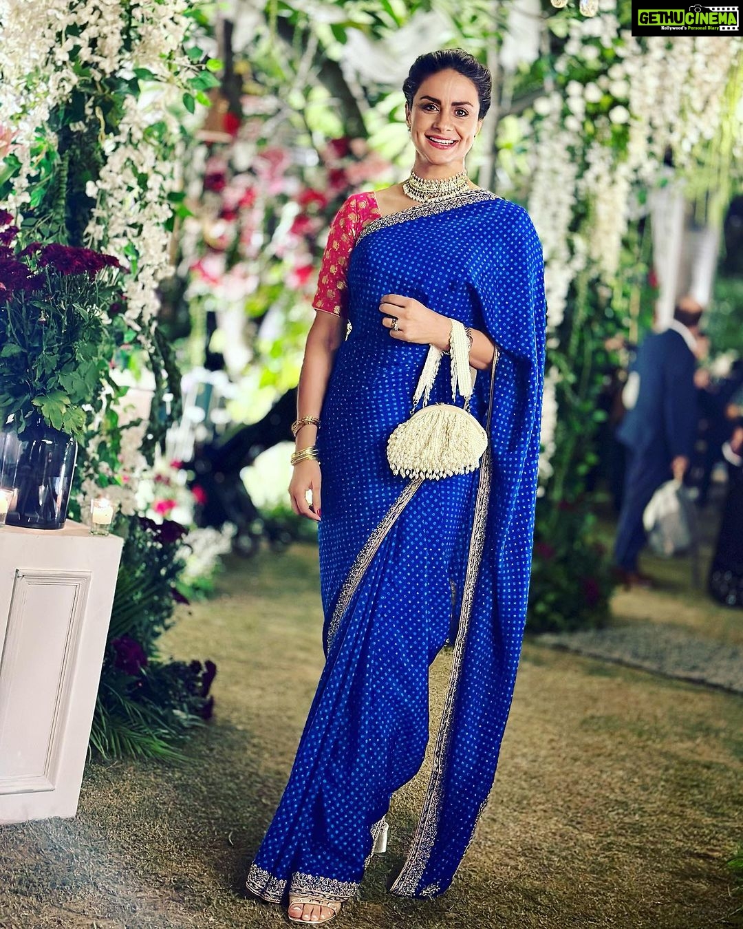 Gul Panag Instagram - The phulkari is such an integral part of our culture. From all things auspicious to all things festive -the phulkari is always there. Either as the main act. Or the supporting one, where we simply carry it on our forearms ( in addition to the full outfit and its own dupatta). At every wedding, shagan, engagement and jaago- the phulkari will ALWAYS make an appearance. Here I’m wearing a bagh ( all over embroidery) from @1469original . Occasion is Vatana. And my outfit is borrowed from @simranpotnis - we’ve decided to have all our clothes in JV now. 😅 Blue sari is @ritukumarhq . From 1999. Qualifies as vintage I suppose Also, managed to get HIM to pose for a picture.😅 @keeratkular thanks for the photos. And for reminding me that the knot clutch exists in my wardrobe. And of course for EVERYTHING else.😂 P.S Phulkari (ਫੁਲਕਾਰੀ) refers to the folk embroidery of the Punjab. Although Phulkari means floral work, the designs include not only flowers but also cover motifs and geometrical shapes. Incidentally, culturally prevalent in Punjab, Pakistan too.