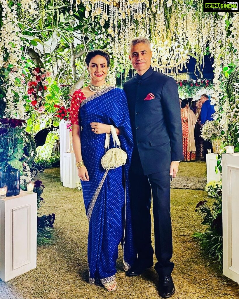 Gul Panag Instagram - The phulkari is such an integral part of our culture. From all things auspicious to all things festive -the phulkari is always there. Either as the main act. Or the supporting one, where we simply carry it on our forearms ( in addition to the full outfit and its own dupatta). At every wedding, shagan, engagement and jaago- the phulkari will ALWAYS make an appearance. Here I’m wearing a bagh ( all over embroidery) from @1469original . Occasion is Vatana. And my outfit is borrowed from @simranpotnis - we’ve decided to have all our clothes in JV now. 😅 Blue sari is @ritukumarhq . From 1999. Qualifies as vintage I suppose Also, managed to get HIM to pose for a picture.😅 @keeratkular thanks for the photos. And for reminding me that the knot clutch exists in my wardrobe. And of course for EVERYTHING else.😂 P.S Phulkari (ਫੁਲਕਾਰੀ) refers to the folk embroidery of the Punjab. Although Phulkari means floral work, the designs include not only flowers but also cover motifs and geometrical shapes. Incidentally, culturally prevalent in Punjab, Pakistan too.