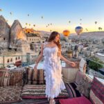 Kritika Sharma Instagram - The most favourite part of my turkey trip to do this 🤍 #gratitude Outfit @sainygargcouture Styled by @_vaishnavii.3011 Location @sultan_cave_suites #travel #whitedress #cappadocia #hotairballoon #photoshoot #terrace Sultan Cave Suites