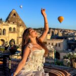 Kritika Sharma Instagram – The most favourite part of my turkey trip to do this 🤍 #gratitude 
Outfit @sainygargcouture 
Styled by @_vaishnavii.3011 
Location @sultan_cave_suites 

#travel #whitedress #cappadocia #hotairballoon #photoshoot #terrace Sultan Cave Suites