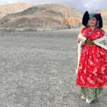 Madhu Sharma Instagram - Ladakhi traditional dress Goncha or Kos or Sulma are the main dress worn by all the communities in Ladakh by both the sexes, accompanied with a colourful sash tied around their waist. The women's robe, however, flares downwards with small pleats accentuating it into a flowy gown.Goncha or Kos is a voluminous robe resembling a coat made of wool, velvet, cotton, polyester, or a combination of these. Pangong Tso