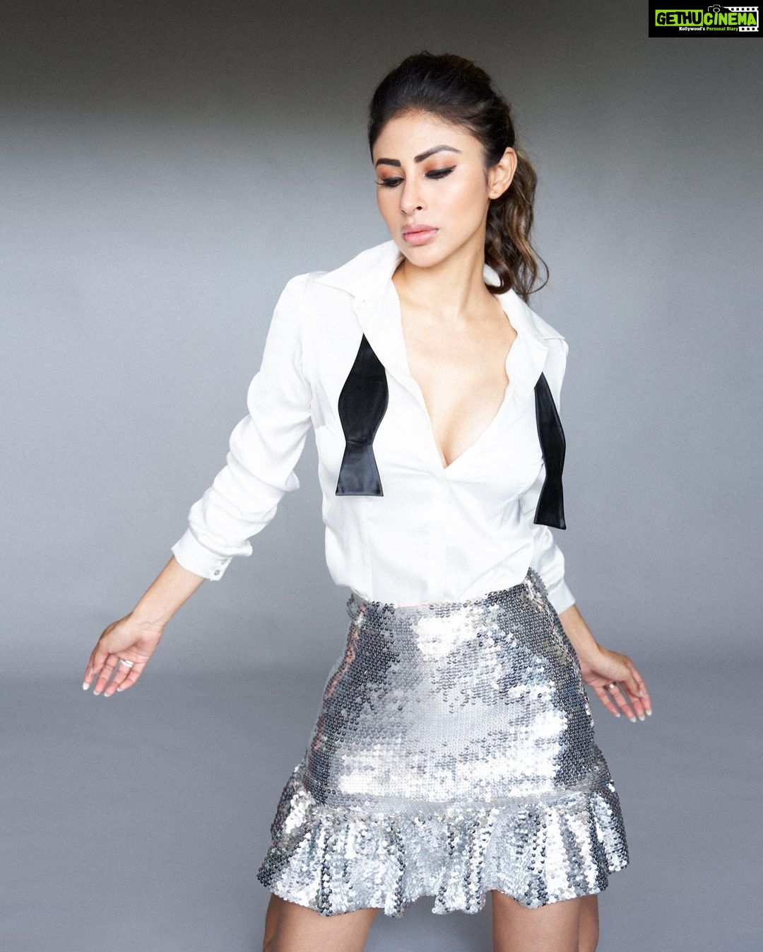 Mouni Roy Instagram - Hustling through life, some good days some bad…. Always grateful x • • • • Skirt by : @rabanne Shirt by : @safiyaa_official Open bow tie by : @tossido.in Heels by : @labelrsvp Styled by : @manekaharisinghani with @chintan_shah08 Hair: @chettiarqueensly Make up: @mukeshpatilmakeup 📷 @tejasnerurkarr