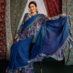 Nisha Agarwal Instagram - Introducing @nishaaggarwal in @rishiandvibhuti for Gajra Gang collection. ✨ Adorning our blue ruffle frill saree crafted in signature prints and delicate lace appliqué, perfect for the festive season. 🔎 Search the code GGRVSAR01 on Nykaa Fashion to shop. 🛒www.nykaafashion.com Exclusively available on Nykaa Fashion. Express Shipping Available. #GajraGang #RishiAndVibhuti #NykaaFashion #Nykaa #JanhviKapoor #Tyohar #NewArrivals #Indianwear #FestiveStyles #FestiveCollection #Diwali #Fashion #Explore #Trending