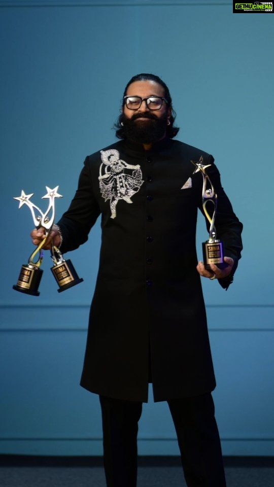 Rishab Shetty Instagram - Triple the applause, triple the glory! @rishabshettyofficial’s star power is unmatched as he poses with his three remarkable awards at SIIMA 2023. #a23rummy #letsplaytogether Danube Properties Presents A23 SIIMAWEEKEND in Dubai on 15th and 16th September