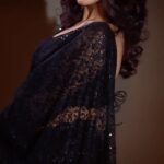 Trina Saha Instagram - This Black net based embroidered Bollywood Saree,has sequin and scalloped border…it’s a must for your wardrobe✨ Don’t forget to add on the bling on your ears 😍 #klothbytrineel