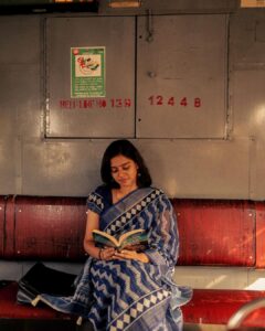 Akshatha Ajit Instagram - She sat by the window, lost in a novel, the rhythmic motion of the air gazing her auburn hair. She was able to feel the whispering sound of the untold stories in the journey, each glance revealed a universe of emotions.The train, an anthology of fleeting moments, carried its cargo of dreams and realities. The Train Tales… to it’s destination. . 📸 @hariz_comrade 🤍