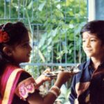 Bhakti Kubavat Instagram - That was my childhood - simple & beautiful - just like a bed of roses. On the left is my mama’s son sunny! The elder brother who was so much fun. We would get chocolates from Tanzania and my nani would send us frocks & games. We were so excited when he would visit us. Next to him is Kanjibhai - the first caretaker who stood next to my dad when he opened his first clinic. My dad taught him everything, from taking an ecg to protecting us when he was not around saving lives. Ofcourse next to him is me - with a red rose and gulabi lipstick, yes i was allowed to wear makeup on special occasions like rakshabandhan, diwali & my birthday, haha. By my side is my twin brother and my partner in crime. For me he was my hero - whatever vicky will do - i WILL do. We would go to school in ghoda-gadi, play playstation, nintendo, cricket & our favorite was “nadi-parvat”, keep the coins on a railway tracks, chill will “kaju”. And above him is Didi - always protective & always helping mom. She would burn bridges if she would see tears in my eyes. She loved me/us fiercely. I would always look forward to weekends for we knew we would be chilling with the lions and the deers at sasan & go on a roadtrip. I’m so proud of my childhood as it was nothing less than a fairytale. I don’t remember i ever cried - yes i mean i would once in a while only when my house help “Lata” would go home or when kaju (the boy who lived in the hut next to the railway tracks - our best friend) would go away for find work near the suburbs. We would wait for him to join us in the evening and tell us some crazy ghost-stories. This was our life! And imagine now, everyday feels like a struggle! I wish i could tell the 5 year old me, that growing up is the most toughest thing. I would’ve got my arms stronger to save myself & protect the people i love. Those were the best days of my life ✨ So my advice, don’t forget to cherish lil moments along the way :) P.S. Did you miss my bindi ? ;)