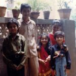 Bhakti Kubavat Instagram - That was my childhood - simple & beautiful - just like a bed of roses. On the left is my mama’s son sunny! The elder brother who was so much fun. We would get chocolates from Tanzania and my nani would send us frocks & games. We were so excited when he would visit us. Next to him is Kanjibhai - the first caretaker who stood next to my dad when he opened his first clinic. My dad taught him everything, from taking an ecg to protecting us when he was not around saving lives. Ofcourse next to him is me - with a red rose and gulabi lipstick, yes i was allowed to wear makeup on special occasions like rakshabandhan, diwali & my birthday, haha. By my side is my twin brother and my partner in crime. For me he was my hero - whatever vicky will do - i WILL do. We would go to school in ghoda-gadi, play playstation, nintendo, cricket & our favorite was “nadi-parvat”, keep the coins on a railway tracks, chill will “kaju”. And above him is Didi - always protective & always helping mom. She would burn bridges if she would see tears in my eyes. She loved me/us fiercely. I would always look forward to weekends for we knew we would be chilling with the lions and the deers at sasan & go on a roadtrip. I’m so proud of my childhood as it was nothing less than a fairytale. I don’t remember i ever cried - yes i mean i would once in a while only when my house help “Lata” would go home or when kaju (the boy who lived in the hut next to the railway tracks - our best friend) would go away for find work near the suburbs. We would wait for him to join us in the evening and tell us some crazy ghost-stories. This was our life! And imagine now, everyday feels like a struggle! I wish i could tell the 5 year old me, that growing up is the most toughest thing. I would’ve got my arms stronger to save myself & protect the people i love. Those were the best days of my life ✨ So my advice, don’t forget to cherish lil moments along the way :) P.S. Did you miss my bindi ? ;)