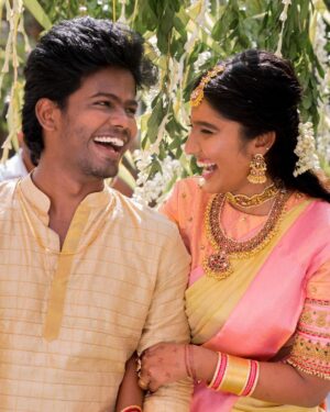 Deepika Venkatachalam Instagram - #Weddinglookbook 
Kerala themed Engagement (5/5) 💕✨

After that breathtaking lehenga, it was time to change for "Ring Exchange" 💍 and we had no heart to change the mood board and color palette for the second outfit! But wanted a quick changeover and went for this pleasantly beautiful gold saree that had a blush pink border adorned with motifs of the tree of life from @muhurth.brand ❤️ We looked into 50+ sarees from multiple brands but my heart said "Go for this"  RVP approved too! 🫶🏼

The saree by itself was a beauty and just to add some grace to it we went on to experiment with blouse designs. That's exactly when @d.sign.d came in and gave us a lot of ideas & finally our choice was this blouse with intricate embroidery that added a hint of simplicity, sophistication and tradition to the overall look❤️

Nextuhhhh....Jewelsuhh😌

Our pro stylist @artra_styling suggested to go for a bright temple look jewelery with bright red stones and emeralds to amp up the saree and I abided by it only to find the perfectly looking set from @vriksham that definitely added the touch of gorgeousness. ✨

Oh yes, for my groom! 🫶🏼 Raja wanted the changeover for the ring exchange to be simple. He preferred a "Veshti" and our stylish gave us the choice of pairing it with a Kurta in the same golden shade. 

As always, his silk veshti and his silk fabric for the kurta were picked from Nalli! 

We took it all to our Malar Akka @fiorebymalar_ and she made the kurta that looked so good on him! 🥺🫶🏼 
Like I said he wanted minimal dress up and just went ahead with his chain and bracelet only! 

I must admit it all fell in place so beautifully for both of us and we got lucky to figure out the finest people around us to ensure everything fell in place and our day was indeed filled with love and love only! 🫶🏼💕
.
📸 @photonimage_by_daran 
Decor @tharunam.in 
Jewellery @vriksham 
Saree @muhurth.brand 
Blouse @d.sign.d 
Styling @artra_styling 
Makeup @kabooki_mua 
.
#RnD #RnDwedding