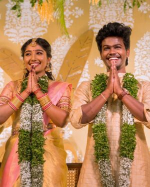Deepika Venkatachalam Instagram - #Weddinglookbook 
Kerala themed Engagement (5/5) 💕✨

After that breathtaking lehenga, it was time to change for "Ring Exchange" 💍 and we had no heart to change the mood board and color palette for the second outfit! But wanted a quick changeover and went for this pleasantly beautiful gold saree that had a blush pink border adorned with motifs of the tree of life from @muhurth.brand ❤️ We looked into 50+ sarees from multiple brands but my heart said "Go for this"  RVP approved too! 🫶🏼

The saree by itself was a beauty and just to add some grace to it we went on to experiment with blouse designs. That's exactly when @d.sign.d came in and gave us a lot of ideas & finally our choice was this blouse with intricate embroidery that added a hint of simplicity, sophistication and tradition to the overall look❤️

Nextuhhhh....Jewelsuhh😌

Our pro stylist @artra_styling suggested to go for a bright temple look jewelery with bright red stones and emeralds to amp up the saree and I abided by it only to find the perfectly looking set from @vriksham that definitely added the touch of gorgeousness. ✨

Oh yes, for my groom! 🫶🏼 Raja wanted the changeover for the ring exchange to be simple. He preferred a "Veshti" and our stylish gave us the choice of pairing it with a Kurta in the same golden shade. 

As always, his silk veshti and his silk fabric for the kurta were picked from Nalli! 

We took it all to our Malar Akka @fiorebymalar_ and she made the kurta that looked so good on him! 🥺🫶🏼 
Like I said he wanted minimal dress up and just went ahead with his chain and bracelet only! 

I must admit it all fell in place so beautifully for both of us and we got lucky to figure out the finest people around us to ensure everything fell in place and our day was indeed filled with love and love only! 🫶🏼💕
.
📸 @photonimage_by_daran 
Decor @tharunam.in 
Jewellery @vriksham 
Saree @muhurth.brand 
Blouse @d.sign.d 
Styling @artra_styling 
Makeup @kabooki_mua 
.
#RnD #RnDwedding