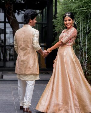 Deepika Venkatachalam Instagram - #Weddinglookbook A kerala themed - Engagement 💕 (2/5)

The moment we decided to have our Engagement depicting Kerala, we were sure to have our outfits reflecting their culture in a unique way that would speak D & RVP. 
Stylist pavi @artra1210 to our rescue and she quickly narrowed down to the mood boards of Ravivarman paintings.

That was it! 

The next morning we found ourselves at @nallisilksarees since it is an emotion in Chennai, a brand that is known for hand woven silks with the authenticity and quality. 
I think all of us would have brought something from Nalli during our childhood. La ? 🥹

Shopping for fabrics was so joyful & in no time our eyes fell on a pure hand-woven brocade silk fabric. I turned towards for her approval and she came up with something so thoughtful. She said we can use this same fabric for my lehenga and Raja's jacket. 🫶🏼 I fell for it! ❤️

Next up was scouting a fabric for my top and we found a beautiful pink! 

Our forever favourite @fiorebymalar_  worked along with our Pavi for days together for this outfit that I dreamt myself in everyday until the big day. It was a sure head turner for me as well when I had the first look at the whole outfit. Don't you feel the same? 🥰 

While Raja wanted his outfit to be subtle & minimal we went on shop a nice Kurta set from @myntra and paired it along with the jacket designed by Pavi (@artra1210 ) and made by Malar akka. ( @fiorebymalar_ )

My jewellery from @rimliboutique and Raja's shoes from @lifestylestores added some more charm to the whole ensemble!! 

The whole outfit planning went on for days before it became a reality and we cannot be more proud about our stylist & designer for giving us these fairytale kinda looks 🤍

More to come from our close to heart happy Kerala themed engagement that showered white and enormous love!🤍🫶🏼
.

📸 @photonimage_by_daran 
Decor @tharunam.in 
Makeup & hair : @kabooki_mua 
.

[ Check the YT link ( in my bio) to watch the engagement film ]
.
#RnD #RnDwedding