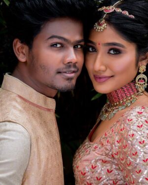 Deepika Venkatachalam Instagram - #Weddinglookbook A kerala themed - Engagement 💕 (2/5)

The moment we decided to have our Engagement depicting Kerala, we were sure to have our outfits reflecting their culture in a unique way that would speak D & RVP. 
Stylist pavi @artra1210 to our rescue and she quickly narrowed down to the mood boards of Ravivarman paintings.

That was it! 

The next morning we found ourselves at @nallisilksarees since it is an emotion in Chennai, a brand that is known for hand woven silks with the authenticity and quality. 
I think all of us would have brought something from Nalli during our childhood. La ? 🥹

Shopping for fabrics was so joyful & in no time our eyes fell on a pure hand-woven brocade silk fabric. I turned towards for her approval and she came up with something so thoughtful. She said we can use this same fabric for my lehenga and Raja's jacket. 🫶🏼 I fell for it! ❤️

Next up was scouting a fabric for my top and we found a beautiful pink! 

Our forever favourite @fiorebymalar_  worked along with our Pavi for days together for this outfit that I dreamt myself in everyday until the big day. It was a sure head turner for me as well when I had the first look at the whole outfit. Don't you feel the same? 🥰 

While Raja wanted his outfit to be subtle & minimal we went on shop a nice Kurta set from @myntra and paired it along with the jacket designed by Pavi (@artra1210 ) and made by Malar akka. ( @fiorebymalar_ )

My jewellery from @rimliboutique and Raja's shoes from @lifestylestores added some more charm to the whole ensemble!! 

The whole outfit planning went on for days before it became a reality and we cannot be more proud about our stylist & designer for giving us these fairytale kinda looks 🤍

More to come from our close to heart happy Kerala themed engagement that showered white and enormous love!🤍🫶🏼
.

📸 @photonimage_by_daran 
Decor @tharunam.in 
Makeup & hair : @kabooki_mua 
.

[ Check the YT link ( in my bio) to watch the engagement film ]
.
#RnD #RnDwedding