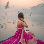 Aakriti Rana Instagram - Before you ask, lag rahi thi thand mujhe 🤣 But fashun is important 📍Yamuna Ghat, Delhi Have you ever been here, visit before all the birds leave. The sunrise here is absolutely breathtaking with thousands of birds flying around. P.s they feed them namkeen there to fly around the boat 🙊 Jitna bada namkeen ka packet, utne zyada birds around your boat. Outfit : @kalkifashion 📸. @shivam.vashisht @shivamphotoworks #aakritirana #yamunaghat #yamunaghatdelhi #sunrise #collab #photography #fashion #lehenga #indianwear #travelblogger #sunrisephotography #dreamy #delhi