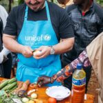 Adam Liaw Instagram – The most rewarding cooking demonstration I’ve ever done. 

Assisting UNICEF’s Mamans Lumière (Light Mothers) program in Ngozi Province. The Mamans Lumière program is where model mothers like Sibomana Christine teach young women about practical nutrition for their children.  Ngozi has one of the highest rates of childhood malnutrition in the world, with latest reports suggesting more than 60% of children experience stunting as a result of severe malnutrition. 

The Light Mothers teach about the balance and sources of macronutrients in ingredients that local women may be able to access, and UNICEF supplements this with a flavourless micronutrient powder containing essential vitamins and minerals for child development.

We made melangé, a nutritious Burundian stew made from whatever ingredients are on hand – in this case beans, lengalenga (amaranth, a Burundian staple), vegetables and small dried fish from Burundi’s Lake Tanganyika. 

The women said I was a good cook, but also commented that they had never seen a man cook before! Ngozi, Burundi
