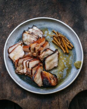 Adam Liaw Instagram - Tonight’s dinner. Misozuke grilled pork belly with yuzu kosho and pickled burdock. Pork belly cured for a day in brown rice miso and ginger, the roasted slowly on the barbecue for about half an hour