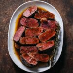 Adam Liaw Instagram - Lamb backstraps with rosemary butter. I hadn’t bought lamb backstraps in years but they were on special so I picked up a few and made this. So easy and so good. Recipe link in my profile.