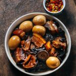 Adam Liaw Instagram – Tonight’s dinner. Braised pork belly with dried squid, shiitake, black fungus, eggs. Flavourings of anise, cassia and black cardamom. Served with chopped cumquats and chilli in soy sauce. 

Condiments like this play a really important role in family cooking to allow flavours and spices to be introduced slowly. My kids prefer this dish without the dried tangerine peel I would normally include, and they are only just starting to like chilli so I put the citrus and chilli on the side and they add a little if they want to, even if it’s just a bit of the soy sauce for the tiniest hint of heat.