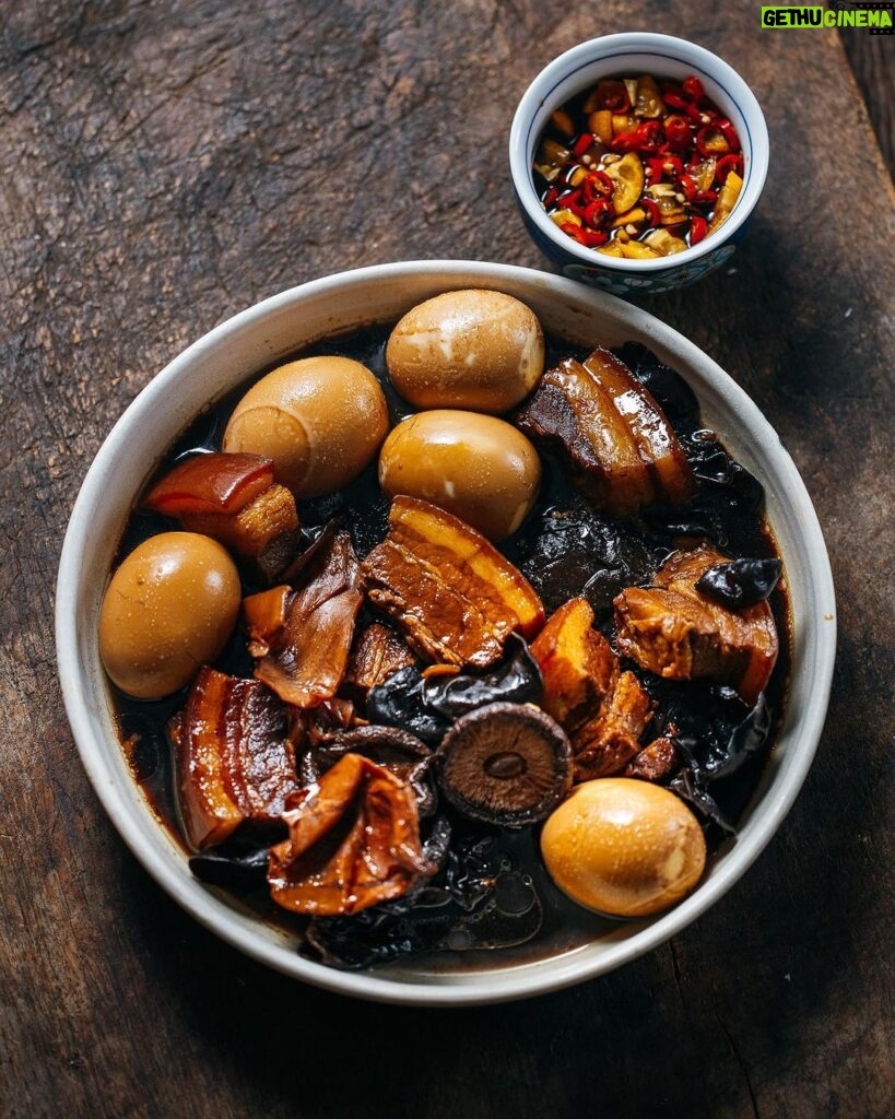 Adam Liaw Instagram - Tonight’s dinner. Braised pork belly with dried squid, shiitake, black fungus, eggs. Flavourings of anise, cassia and black cardamom. Served with chopped cumquats and chilli in soy sauce. Condiments like this play a really important role in family cooking to allow flavours and spices to be introduced slowly. My kids prefer this dish without the dried tangerine peel I would normally include, and they are only just starting to like chilli so I put the citrus and chilli on the side and they add a little if they want to, even if it’s just a bit of the soy sauce for the tiniest hint of heat.