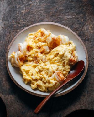 Adam Liaw Instagram - Tonight’s dinner. Stir-fried prawns and eggs. I truly can’t get over how simple stir-frying makes every meal. It’s honestly just seasoning and cooking ingredients in the easiest and most efficient way possible, while using only one pan. 

This is literally two ingredients (prawns and eggs) plus a few seasonings (salt, sesame oil and a little MSG). The prawns are seasoned with salt and a pinch of bicarb, the eggs are seasoned with sesame oil, salt and MSG, and just a touch of cornstarch slurry so the eggs don’t weep. Fry the prawns, remove from the wok. Fry the egg and when nearly set, return the prawns to the eggs. We had this with some gailan with oyster sauce and a simple clear soup (made from the prawn shells with a few mushrooms and a bit of cabbage).