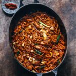 Adam Liaw Instagram – Tonight’s dinner. Pork and octopus braised Hokkien noodles. If you stir-fry noodles you can only really do so in batches for 1 or 2, which makes braised noodles so much easier for family cooking. This is a kilo of noodles cooked all at once to serve 5, and by “braised” I mean they only “braise” for about 2 minutes and they absorb the sauce so they come out quite dry. I rendered pork fat to fry the noodles Malaysian-style in lard (and to make the chu yau char – crispy pork fat) but if you didn’t do that this is a 10 minute start to finish dish.