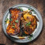 Adam Liaw Instagram - Tonight’s dinner. Pumpkin and cauliflower with garlic yoghurt and smoked paprika butter. This honestly couldn’t be easier and you don’t even need to pick up a knife. Heat an oven to as hot as it will go. Buy a half butternut and half cauliflower. Microwave the butternut for 5 minutes then place both the butternut and cauliflower cut-side down on an oiled piece of baking paper and bake for 30 minutes (you can leave all the leaves on the cauliflower). Grate some garlic into some yoghurt and season with salt. Spread it on a plate and put the vegetables on top. Season with salt again. Heat a little butter or olive oil in a saucepan and add a bit of smoked paprika. Pour it over. Tear over a bit of parsley.