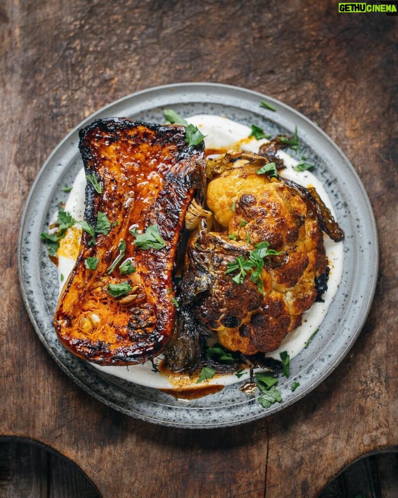 Adam Liaw Instagram - Tonight’s dinner. Pumpkin and cauliflower with garlic yoghurt and smoked paprika butter. This honestly couldn’t be easier and you don’t even need to pick up a knife. Heat an oven to as hot as it will go. Buy a half butternut and half cauliflower. Microwave the butternut for 5 minutes then place both the butternut and cauliflower cut-side down on an oiled piece of baking paper and bake for 30 minutes (you can leave all the leaves on the cauliflower). Grate some garlic into some yoghurt and season with salt. Spread it on a plate and put the vegetables on top. Season with salt again. Heat a little butter or olive oil in a saucepan and add a bit of smoked paprika. Pour it over. Tear over a bit of parsley.