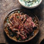 Adam Liaw Instagram – Tonight’s dinner. Scotch fillet with caramelised onion and portobello mushroom sauce. Creamed spinach. One very simple but very effective trick for pan sauces like this is that if you’re using commercial beef stock (which most of us are at home) rather than home made, commercial stocks have a lot of the gelatine removed so that it doesn’t clump in the packet at room temperature or in the fridge. The problem is that this gelatine is important for the mouthfeel of a reduced pan jus. Who hasn’t wondered why their pan sauce isn’t thickening the way it’s supposed to. Thankfully the answer is very simple, I add a half teaspoon of powdered gelatine to the sauce to improve the thickening and mouthfeel. It works wonders. 👍