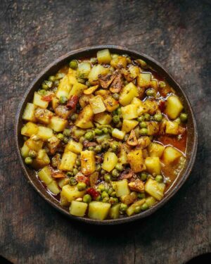 Adam Liaw Instagram - Tonight’s dinner. Aloo matar with brown butter garlic tadka. Aloo matar (potatoes and peas) is a classic Indian dish cooked with cumin and spices of which there are endless variations. The addition of the brown butter tadka is a game-changer (if I do say so myself). So good.