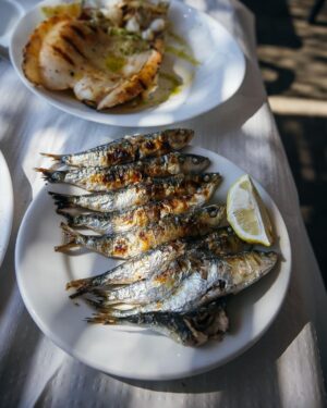 Adam Liaw Instagram - Spanish yum cha? Visiting my brother who lives in a village just outside Malaga. Seaside restaurants right on the beach serving seafood grilled over hot coals. Waiter walk around with the plates and you just grab what passes you by. The bill is tallied up at the end and written straight on the paper lining the table. With a few glasses of tinto de verano it’s the best way to spend a warm afternoon.
