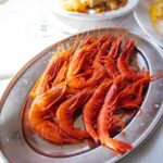 Adam Liaw Instagram - Spanish yum cha? Visiting my brother who lives in a village just outside Malaga. Seaside restaurants right on the beach serving seafood grilled over hot coals. Waiter walk around with the plates and you just grab what passes you by. The bill is tallied up at the end and written straight on the paper lining the table. With a few glasses of tinto de verano it’s the best way to spend a warm afternoon. El Tintero, El Palo